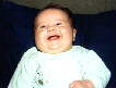Grinning! Two months old today. . .