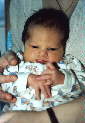 Sitting up in mummy's arms, 15 March 2000